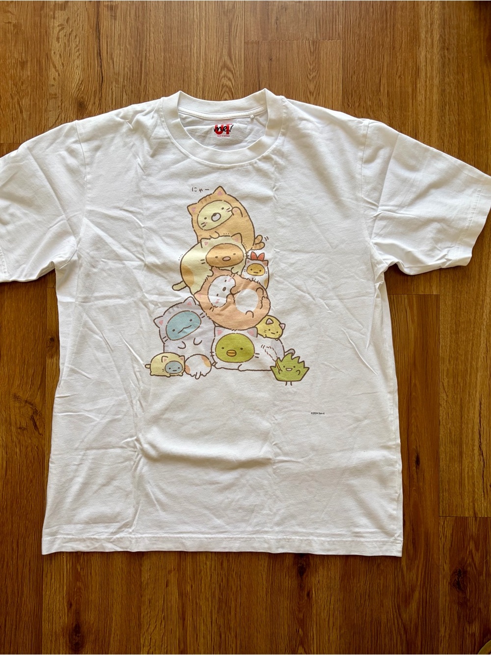 Uniqlo White Short Sleeve Tee with Pastel Character Stack Print